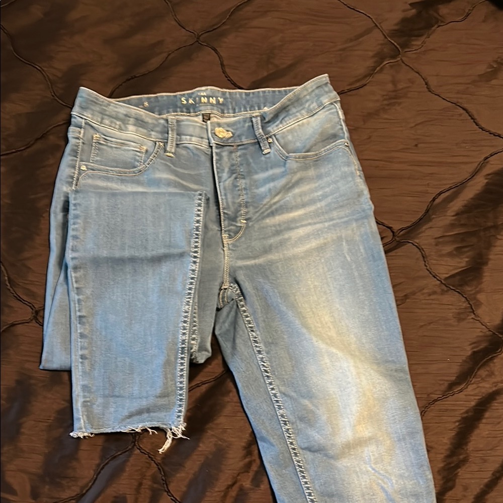 White House Black Market.        Blue Skinny Jeans with Distressed Look